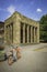 An old buiding with pillars at the front and side with a bicycle in front in Dusseldorf, Germany on a sunny day.