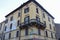 Old building with corner balcony in historic center of Spilamberto, Italy