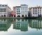 Old building facades reflecting in the Nive River in Bayonne, France