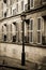 Old building with lamp post in Paris in sepia