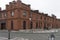 An old building made of red brick on the embankment of the Tsarevich.