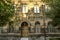 Old building of multicolored tufa stone with carved arches