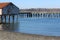 An old building on a run down pier in a bay