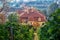 Old building with a tiled roof in the fall with rows of vineyard on sunny day in the autumn