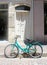 Old building with white door and vintage parked bicycle, Greece