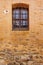 Old Building Yellow Stone Wall With Window And Rusty Bars