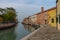 Old buildings in Murano island. Canal view with boats. Travel photo.