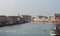 Old buildings in Murano island. Canal view with boats. Travel photo.