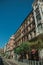 Old buildings with shops and people on a busy street of Madrid