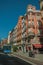 Old buildings with shops and people on a busy street of Madrid