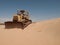 An old bulldozer abandoned in the middle of the desert in Saudi Arabia