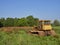 An Old Bulldozer in a Farm Field near Letham in Angus, Scotland, Its yellow Cabin rusted with age.