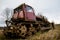 Old bulldozer standing alone in a field. Earthworks, old bulldozer on caterpillars.