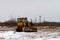 Old bulldozer in an uncultivated field in winter