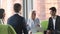 Old businesswoman talking to diverse partners at international business negotiations