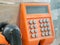 Old button number on orange public telephone