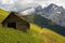 Old cabin in Dolomites with Marmolada peak on the background