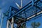 old cable car metal construction, blue white pillars, summer sky in sunlight