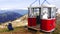 Old cable way lift gondola cab abandoned in peak panorama of Monte Baldo mountain near Malcesine in Italy