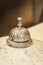 An old call bell on a granite countertop for customers to ring service personnel.