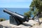 Old cannon and anchor by path, Adriatic sea Rovinj