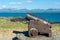 Old cannon on Anglesey Island, Menai Strait and Snowdonia mountains in the background