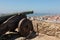 Old Cannon at Castelo de Sao Jorge, Aerial view of Lisbon and 25th April Bridge, Portugal.