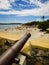 Old cannon inside Santa Cruz Fort, Orange beach below - Itamaraca Island, Brazil