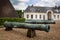 Old canons in front of large former conical glass making kiln in Chateau Verrerie, Le Creusot, France