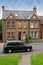 Old car in front of a typical house in Harlow, UK