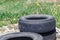 Old car tires lying among the grass. Environmental pollution