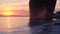 Old cargo ship aground at sea harbour during sunset