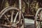 Old carriage with rusty wheels and pumpkins