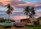 Old Cars on the coast against ocean and Palm trees during sunset