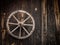 Old cartwheel hanging on a wooden barn