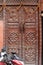 Old carved brown wooden door in Kathmandu