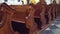Old carved wooden benches in catholic church 4K steadicam video