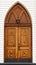 Old carved wooden church door with lantern