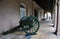 Old cast-iron cannon near the museum on the street in New Orleans. Cityscape