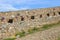 Old castle wall with blooming wild flowers on Palamidi Castle in Nafplio, Greece.