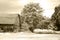 Old cedar sided country barn with carriage Sepia
