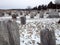 Old cemetery gravestones with snow