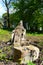 Old cemetery. Old neglected, mutilated figures of saints and crosses on graves. Remains of tombstones.