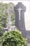 The old cemetery. Overgrown tombstone with two angels.