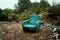 The old chair is in a landfill. Abandoned wasteland with waste and garbage