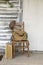 Old chair with rustic canvas bag and suitcase