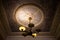 Old chandelier on the ceiling with stucco molding