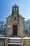 Old chapel with a bell tower on the background of the mountains. Stairs, Church and bell tower.