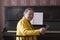 Old charming lady pianist in the yellow jacket seating at the piano