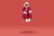 Old cheerful grey-haired man wearing Santa style is sitting levitating in air on red background.